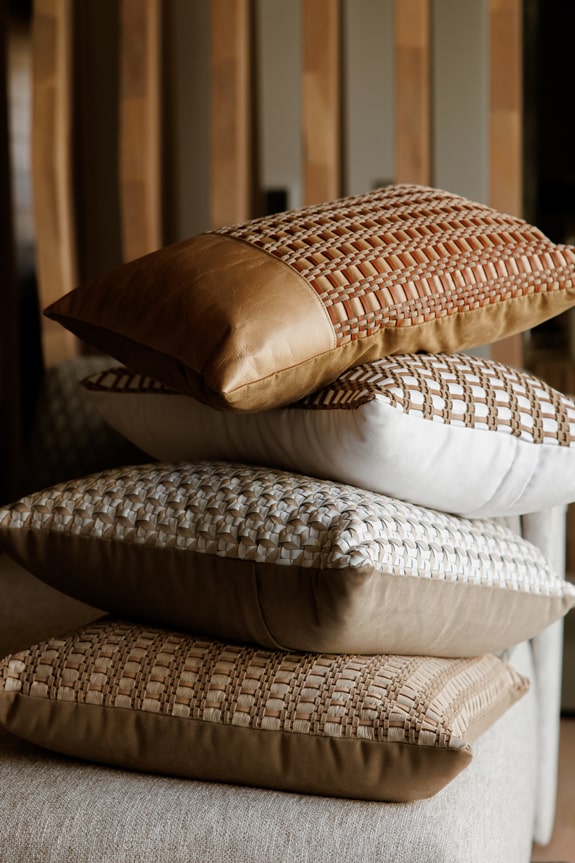 tressera leather cushions stacked on top of each other
